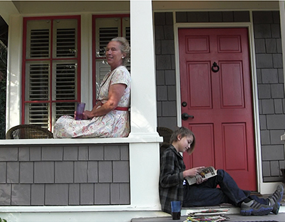 Aunt Velma Considers Changing Religion - a woman and her nephew sitting on a front porch